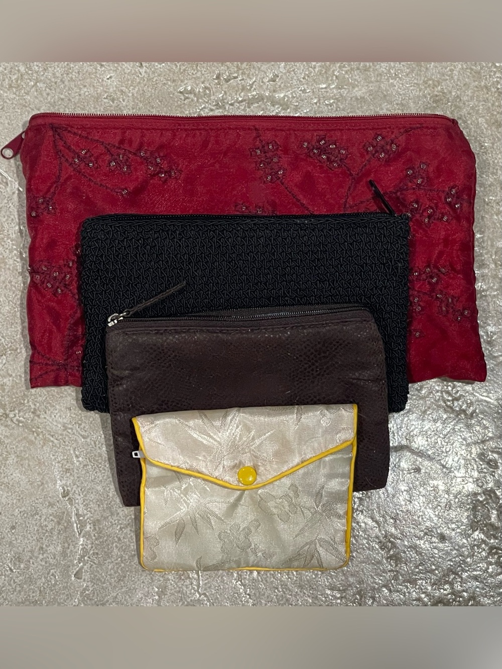 Set of Women's Clutch and Pouch Makeup Wallets in Red, Black, Brown, and Cream